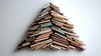 Stack of books arranged in triangular pyramid shape against white wall, creating minimalist composition for education, knowledge and learning concepts.
