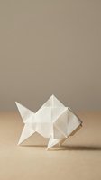 White origami fish crafted from folded paper, placed on a beige surface with a neutral background, showcasing Japanese paper art.