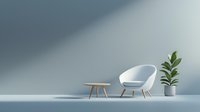 Modern white armchair with wooden side table and potted plant in minimalist interior setting against light blue wall with dramatic shadow casting.