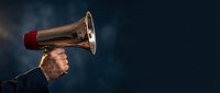 Young woman with flowing hair shouting through vintage megaphone against dramatic dark blue background for communication and announcement concepts.