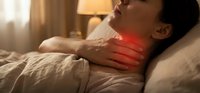 Young Asian man experiencing severe sore throat pain while lying in bed, holding neck with red inflammation highlight showing discomfort and illness symptoms.