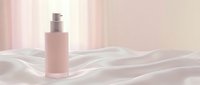 Elegant pink cosmetic bottle with pump dispenser on soft white fabric waves, minimalist skincare product display with natural light and neutral background.