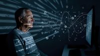 Senior male scientist analyzing complex data visualization on computer screen with digital network connections and mathematical formulas in modern laboratory.