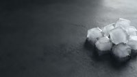 Pile of white sugar cubes on dark textured surface, suitable for food and beverage advertising, culinary content, and nutrition-related designs.