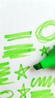 Bright green marker with hand-drawn strokes, stars, circles, and wavy lines on white background. Isolated design element suitable for graphic design, educational materials, and creative projects.