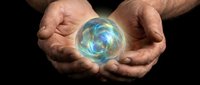 Male hands cupping glowing blue energy orb with swirling light patterns against dark background for spiritual healing and mystical power concepts.