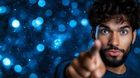 Young Middle Eastern man with beard pointing finger at camera against blue bokeh background, expressing confidence and leadership. Modern portrait with dramatic lighting.