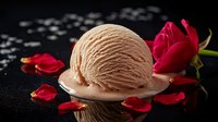 Creamy chocolate ice cream scoop on dark background with fresh red rose petals creating romantic mood, reflection on black surface. Elegant dessert setup.