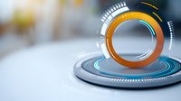 Futuristic circular hologram interface with orange and blue glowing elements on light background, technology concept for digital presentations.