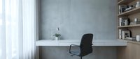 Minimalist home office workspace with white desk, black chair, concrete wall, wooden shelving, and natural light from window for remote work.
