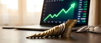 Stacked coins arranged in ascending order with upward trending graph on monitor, symbolizing financial growth, investment returns, and economic success for business concepts.