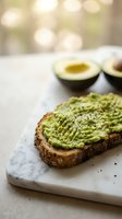 Fresh avocado toast on whole grain bread with sesame seeds on marble cutting board, healthy breakfast meal for morning nutrition and wellness lifestyle.