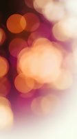 Soft bokeh lights in warm orange, pink, and cream tones create an elegant, dreamy atmosphere. Blurred circular light orbs blend seamlessly for festive, romantic, or celebratory backgrounds and overlays.