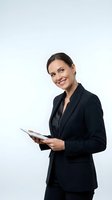 Professional businesswoman in black suit holding tablet computer smiling confidently on white background for corporate presentations and marketing materials.