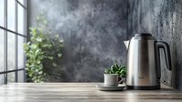 Stainless steel electric kettle with steam rising on wooden table near window, green plant in white pot, moody atmosphere for kitchen and home decor styling.