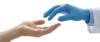 Medical professional in blue latex gloves reaching toward patient's open palm in healthcare consultation setting on white background.