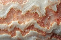 Natural pink and white onyx stone surface with wavy layers and veined patterns showing crystalline mineral structure in macro photography detail.