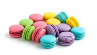 Colorful French macarons in pastel shades isolated on white background. Sweet almond cookies for bakery, dessert menu, confectionery business and culinary projects.
