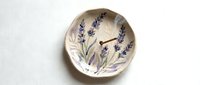 Ceramic bowl with hand-painted lavender flowers and botanical details, isolated on white background for home decor and tableware design projects.