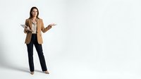 Professional businesswoman in beige blazer presenting with open palm gesture on white background, corporate communication and leadership concept.