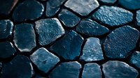 Wet dark blue cobblestone pavement with water droplets creating reflective surface texture for architectural and urban design backgrounds.