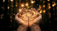 Cupped hands holding magical golden light with sparkling bokeh effects against dark background for spiritual and inspirational concepts.