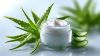 Moisturizing cream jar with fresh aloe vera leaves and cut pieces on light background, natural organic skincare and beauty product photography.