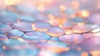 Delicate fairy lights create dreamy bokeh effect over abstract water drops pattern in soft pink and blue tones, macro photography for romantic atmosphere.