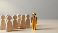 Golden figure standing out from wooden team representing leadership excellence and career advancement in corporate business environment.