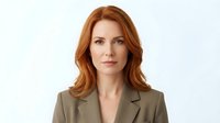Professional redhead businesswoman in olive green blazer suit isolated on white background for corporate presentations and marketing materials.
