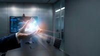 Businessman holding glowing digital hologram with data visualization and light effects in modern office environment for technology and innovation concepts.