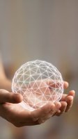Hands holding glowing geometric sphere with triangular wireframe pattern representing innovation, technology, and digital transformation concepts.