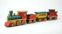 Wooden toy train set with colorful locomotive, passenger cars, and caboose featuring red, yellow, and blue painted details. Suitable for children's toys, nursery decor, and educational content.