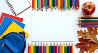 Back to school supplies frame with colorful pencils, notebooks, backpack and autumn leaves on white background for educational design projects.