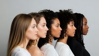 Five diverse women in profile showing different ethnicities and hair textures representing multicultural beauty and unity in modern society.