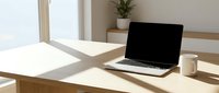 Modern minimalist home office workspace with laptop computer and coffee mug on wooden desk near bright window with natural sunlight for remote work productivity.