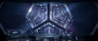 Futuristic symmetrical crystal structure with glowing geometric patterns and digital technology elements on dark background for sci-fi design projects.