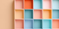 Colorful pastel square compartments in pink, orange, and turquoise shades create modern geometric pattern on wall, minimalist design background for storage display.