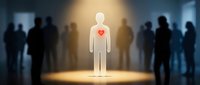 Glowing white human figure with red heart stands out from crowd of dark silhouettes in spotlight, representing uniqueness, compassion and leadership.