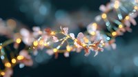 Delicate pink cherry blossoms branch with soft bokeh lights creating magical spring atmosphere, romantic floral composition on dark teal background.