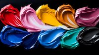 Vibrant cosmetic cream swatches in rainbow colors against black background showcase smooth texture and glossy finish for makeup and beauty industry use.