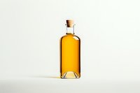 Glass bottle with golden amber liquid and cork stopper on white background, casting soft shadow. Clean minimalist product photography for beverage industry.