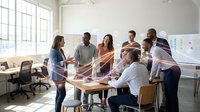 Diverse team of young professionals joining hands together in modern office space during team building activity, showing unity and collaboration in workplace environment.