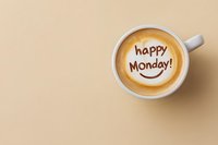 Cappuccino with happy monday message and smiley face latte art on beige background with copy space, viewed from above. Positive morning concept.