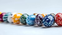 Colorful decorated Easter eggs in line showing traditional folk art patterns and ornate designs against white background, celebrating spring holiday traditions.