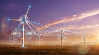 Wind turbines with digital network connections at sunset showcasing renewable energy technology and smart grid infrastructure for sustainable power.