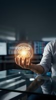 Male professional in light blue shirt holding glowing gear icon in palm against blurred office background with multiple computer monitors, representing innovation, technology solutions, and business process optimization.