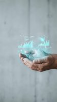 Mature male hand holding digital globe with glowing turquoise data analytics charts, bar graphs and network connections representing global business intelligence and financial growth.