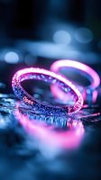 Glowing pink neon bracelet with sparkles on dark reflective surface creates magical atmosphere with blue bokeh lights in background. For nightlife and party designs.