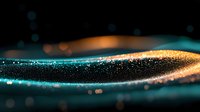 Magical glowing wave of turquoise and gold particles flowing on dark background with bokeh effect, creating dynamic abstract light trail pattern.